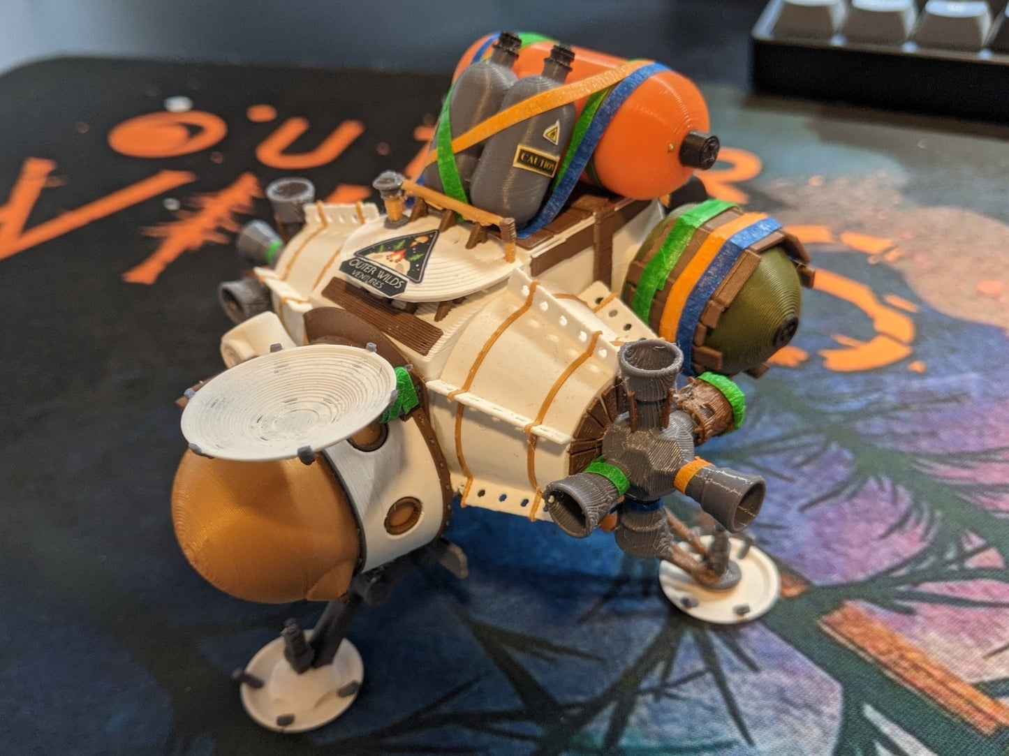 Outer wilds ship on top of desk mat