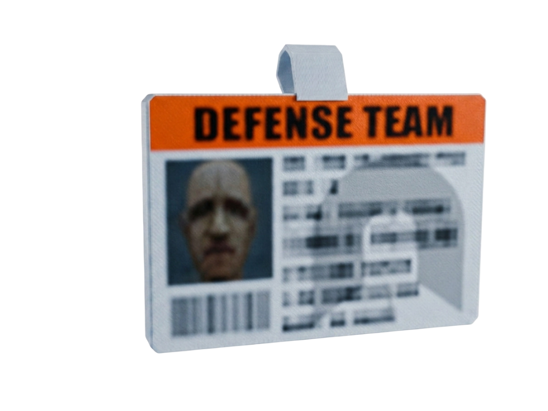 ID card with 'Defense Team' text and a photo of a person on a white background