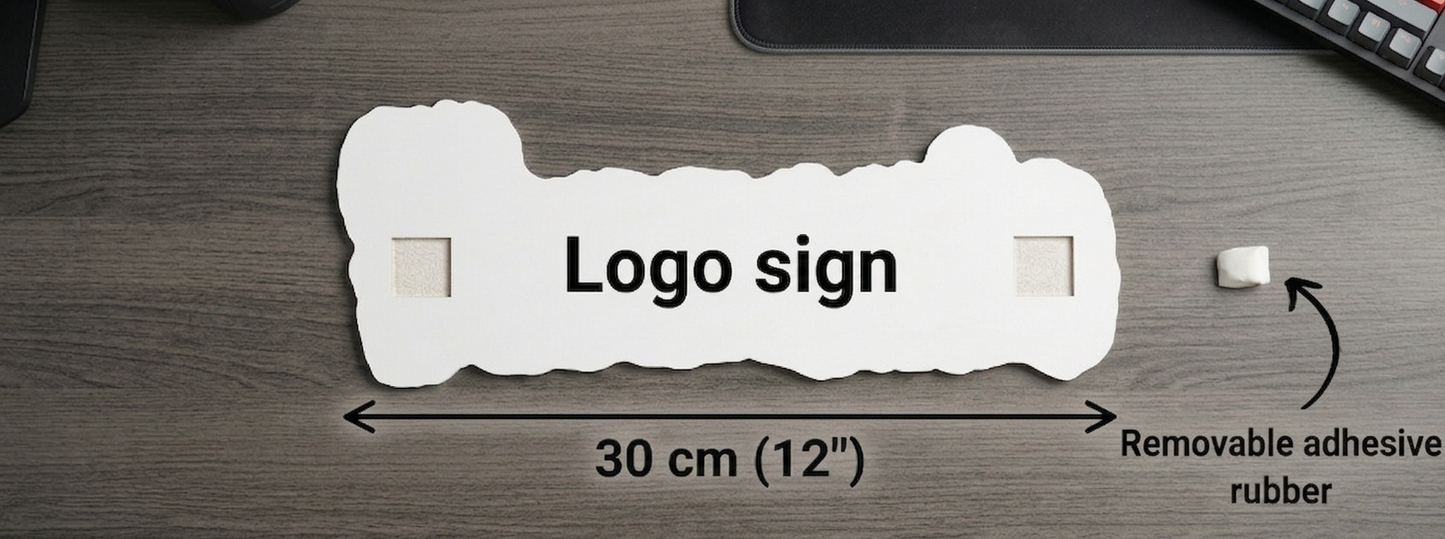 White logo sign with text and measurements on a wooden surface