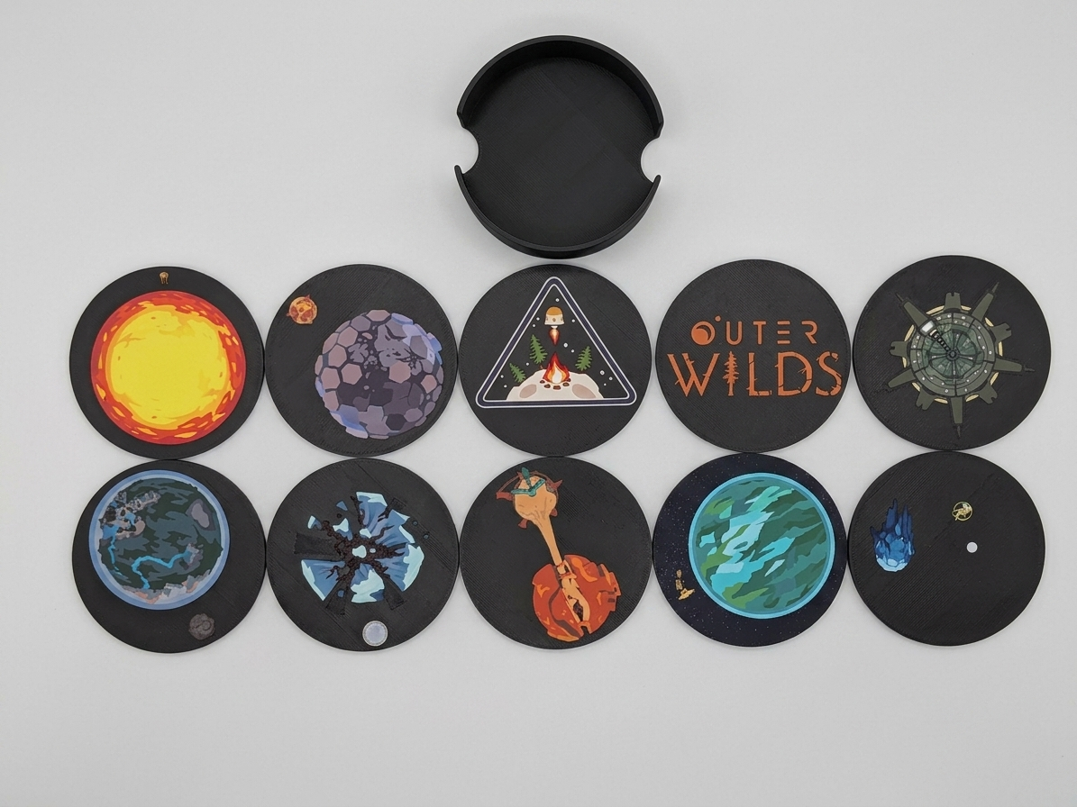 Collection of black circular coasters with various designs on a white background