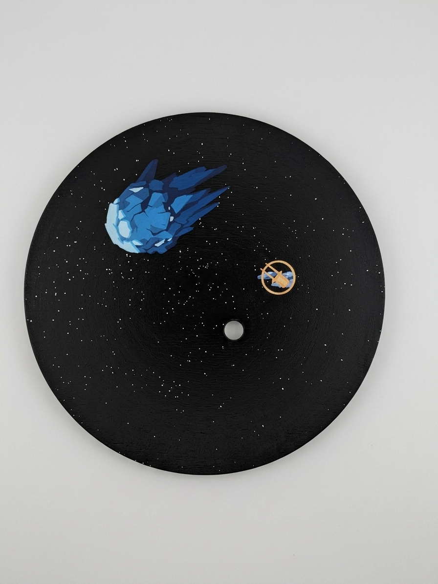 Black clock face with space-themed design including a blue asteroid, white moon, and gold planet on a gray background