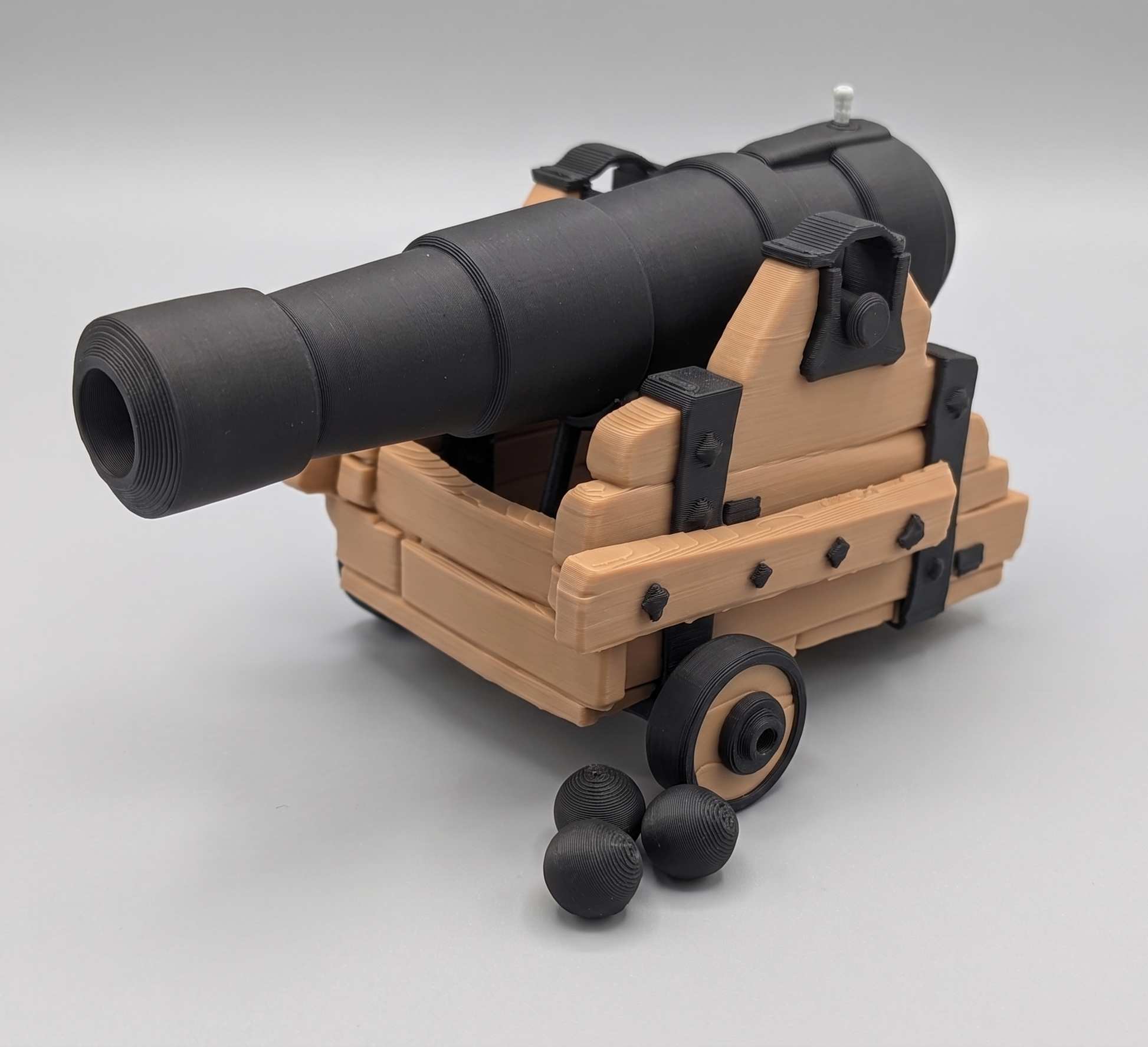 Model of a cannon on wheels with a gray background